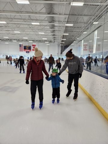 Family skating together at the Whitney Rink in the M&M Center