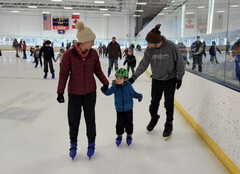 Family skating together at the Whitney Rink in the M&M Center