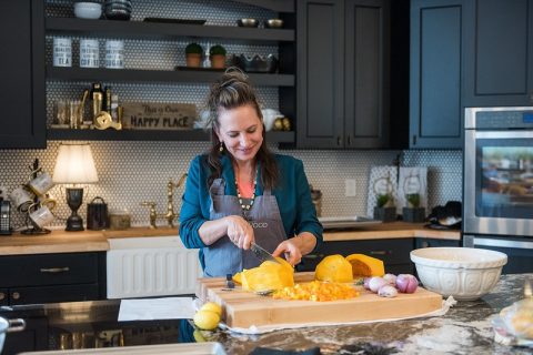 The cooking instructor showing hands-on cooking class in Sheridan, WY, a fun and romantic date idea for learning new recipes together.