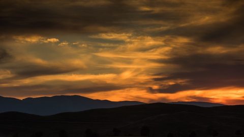 Beautiful sunset at Sheridan Scenic Overlook, a romantic date idea and serene spot for couples to watch the Wyoming sky transform.